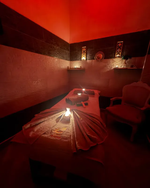 Treatment room in warm light with embroidered towels, Arko Prestige Spa