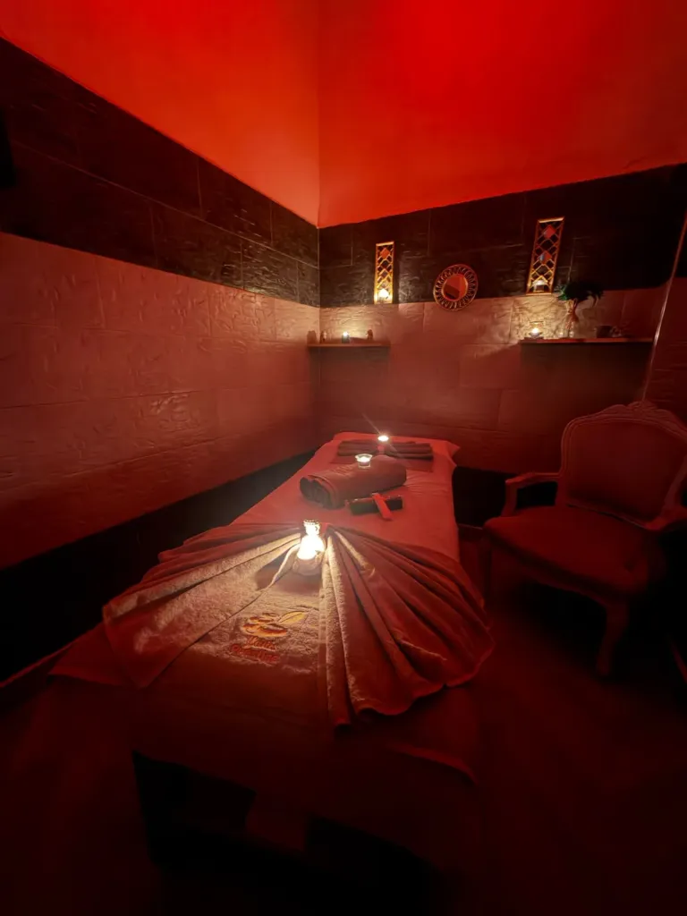 Treatment room in warm light with embroidered towels, Arko Prestige Spa