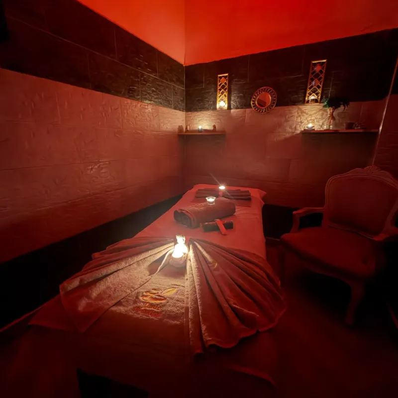 Treatment room in warm light with embroidered towels, Arko Prestige Spa